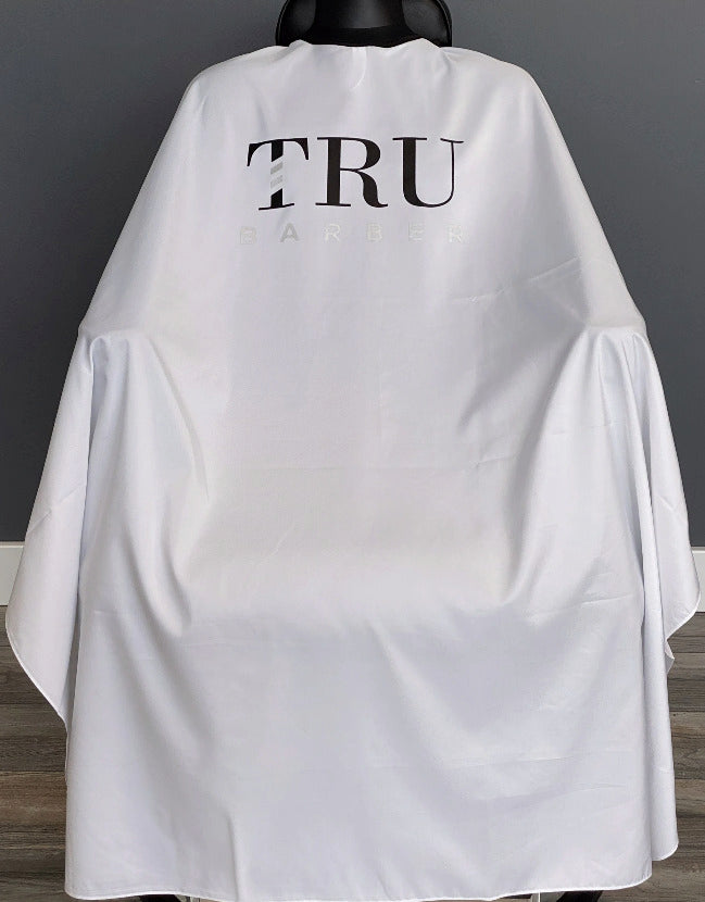 TRUBARBER PROFESSIONAL BARBER CAPE – White With Black Letters